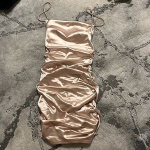 Gold shiny women’s dress with ruching on sides and back, open back